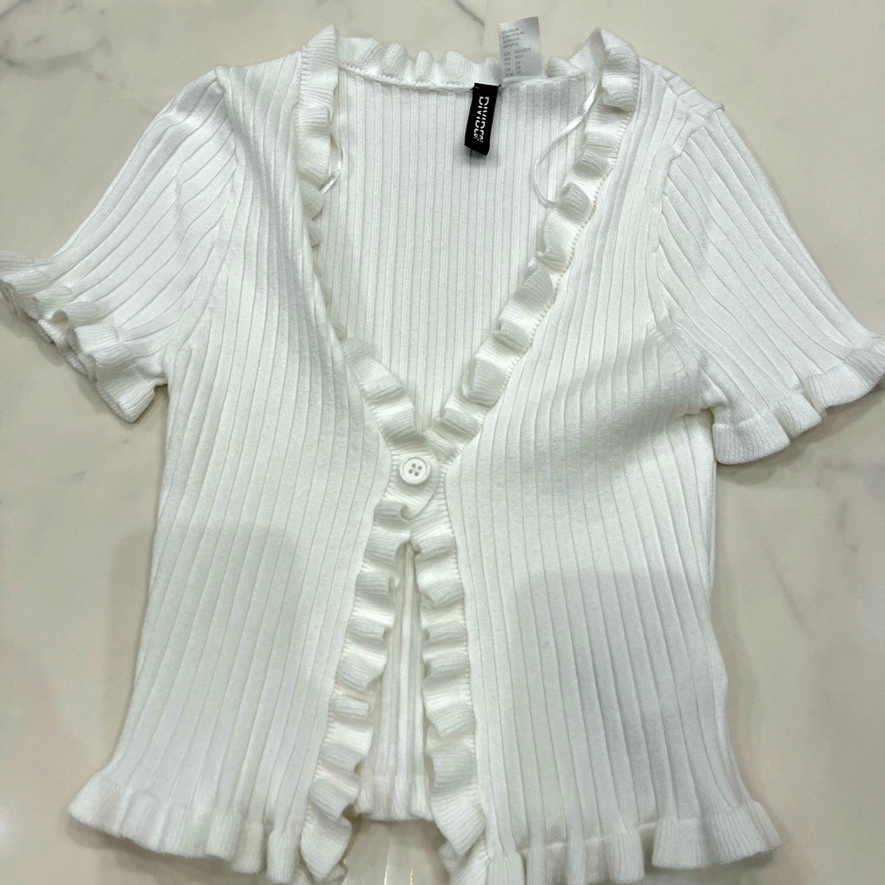 White button-up sweater with ruffles around edges!